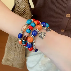 Detailed view of Bohemian multi-layer beaded bracelet set with elephant and heart charms