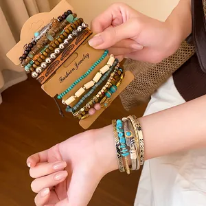 Detailed view of bohemian multilayer leather and glass bead bracelet set on wrist