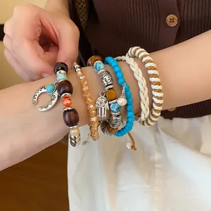 Detailed view of bohemian multi-layer bracelet set with leather and glass beads