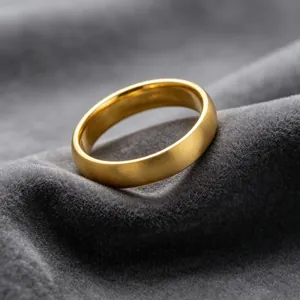 Close-up of golden brushed titanium steel ring with polished interior on grey velvet