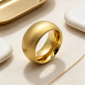 Close-up of a gold titanium steel ring with a brushed exterior and polished interior