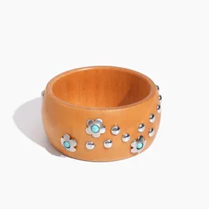 Retro wooden bangle bracelet featuring silver flower studs with turquoise stone centers