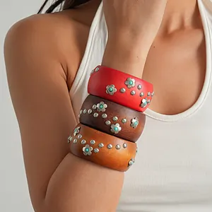 Detailed close-up of vintage resin wood bangles with metallic flowers and silver studs