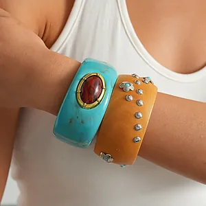 Close-up of vintage resin bangles with turquoise marbling and silver floral rivets