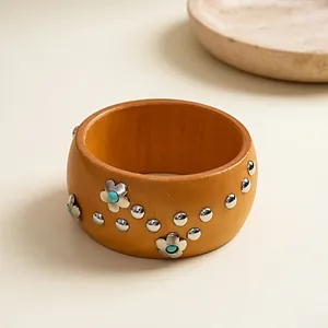 Detailed view of retro resin wood bangle with silver flowers and turquoise accents