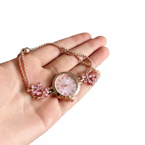 Rose gold bracelet watch with pink crystal flowers and adjustable chain strap