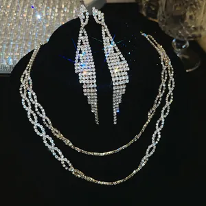 Detailopname van elegante zirkonia kwastjes oorbellen en dubbellaagse kettingset