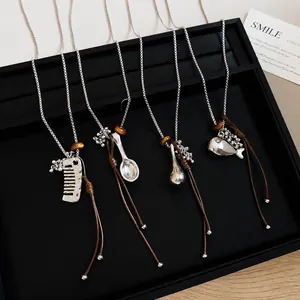 Korean minimalist resin fish pendant necklace with brown leather cord and silver chain