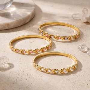 Close-up of three 18k gold-plated stainless steel bangles with colorful marquise zircons
