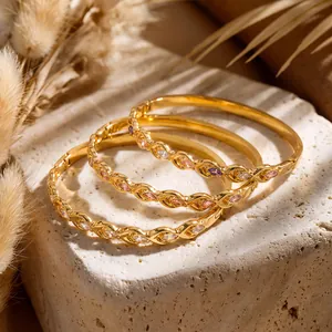 Detail view of 18k gold plated stainless steel bangles with colorful cz stones.