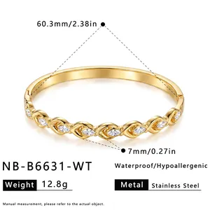 Detail shot of a gold stainless steel bangle with zircon accents and size measurements.