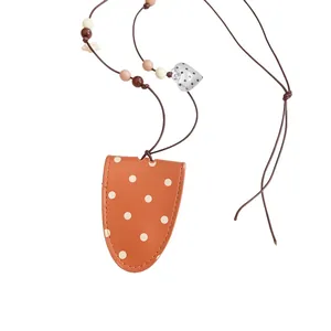 Korean style polka dot leather glasses pouch necklace with heart charm on white background