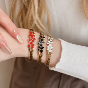 Vintage enamel flower bangles set in red black and white worn on wrist