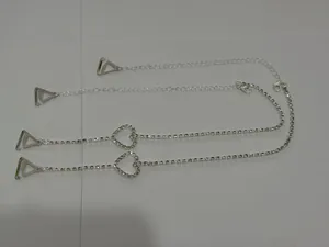 Close-up of elegant silver rhinestone bra straps featuring heart-shaped decorative elements