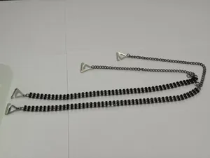 Detail showing black rhinestone embellishments and triangular metal buckles on bra straps
