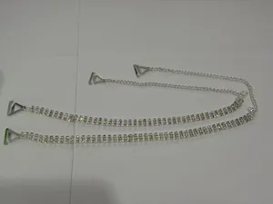 Close-up view of elegant silver rhinestone bra straps featuring sparkling crystals and triangular hooks