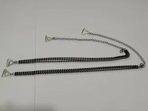 Detailed view of black rhinestone decorative bra straps with silver adjustable chains