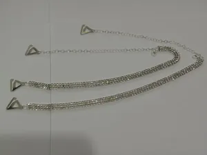 Detail view of shimmering triple-row rhinestone decorative bra straps with adjustable chain.