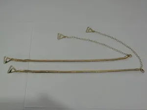 Close-up detail view of golden snake-chain metal bra straps featuring triangular clips.