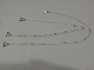 Detailed view of silver layered body chain with rhinestones and triangle clips