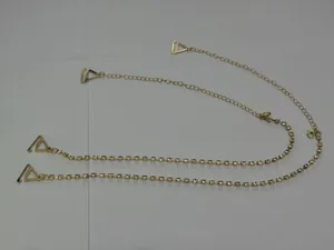 Detail view of gold rhinestone bra straps featuring adjustable chain and triangle clips