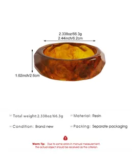 Close-up detail of a vintage marbled resin wide bangle with unique faceted amber texture