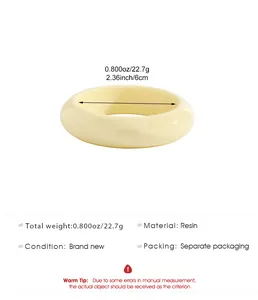 Detailed view of cream resin bangle with weight and size specifications