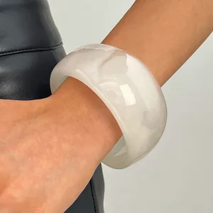 Detailed macro view of a wide semi-translucent white retro resin bangle for women