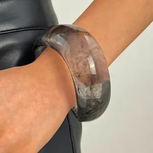 Detailed close-up of a vintage wide resin bangle featuring a unique grey marbled ink pattern
