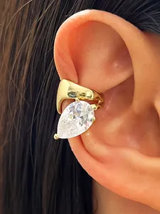 Close-up of golden twisted ear cuff with a large water drop clear zirconia stone