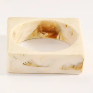 Macro view showing the cream and brown tortoiseshell texture of this vintage resin bangle