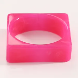 Detailed macro shot of a vintage pink marbled resin bangle with wide acrylic texture and square shape