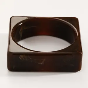 Detailed close-up showing the vintage brown marble resin pattern of this square wide bangle