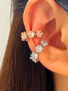Macro detail view of gold and silver plated ear cuffs with sparkling round zircon stones