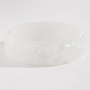 Detailed macro view showing the unique crater-like texture of the white resin bracelet.
