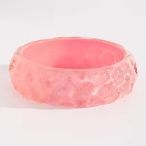 Detailed close-up of a vintage pink resin wide bangle with unique dyed pattern and texture