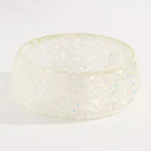 Detailed view of iridescent white resin wide bangle with holographic flakes