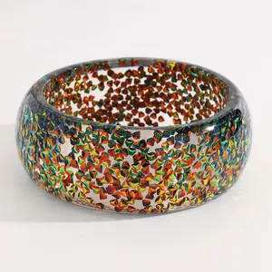 Close-up of vintage wide resin bangle with colorful embedded geometric sequins