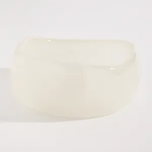 Macro detail of a minimalist chunky off-white resin bangle with a smooth glossy finish