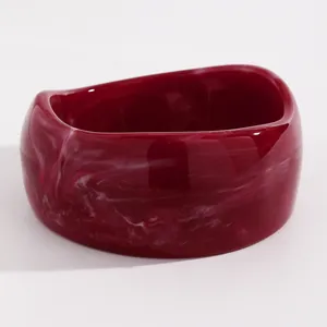 Detailed view of dark red marbled resin chunky bangle with unique white swirl patterns