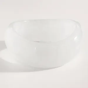 Macro detail view showing the smooth texture of a minimalist wide white resin bangle.