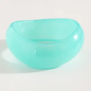 Macro detail of a vintage turquoise resin wide bangle with translucent jelly texture