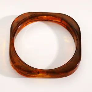 Top view of a wide resin bangle with vintage amber tortoiseshell pattern swirls