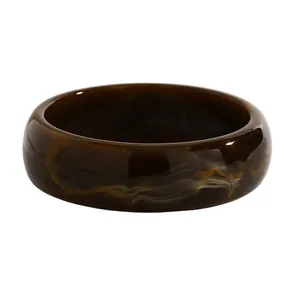 Detailed view of the marbled pattern on the vintage dark brown resin wide bangle.