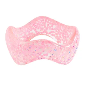 Detailed view of the wavy translucent pink resin bangle with sparkling glitter flakes
