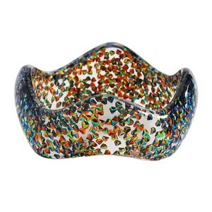 Detailed macro view of wavy resin bangle with iridescent multi-color glitter inclusions.