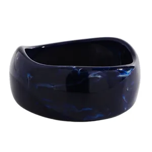 Detail of deep blue marbled resin wide bangle with polished vintage ink-wash pattern