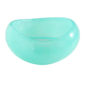 Detailed macro view of a chunky mint green resin bangle with smooth vintage finish.