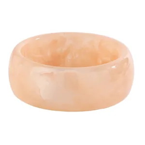 Detailed view of retro marbled resin wide bangle with elegant peach swirl pattern