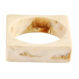 Detailed view of a vintage marbled resin wide bangle in cream and brown